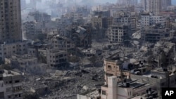 Palestinski broj poginulih premašio je 20.000, a satelitski podaci pokazuju da je jedna trećina struktura širom male enklave uništena. (AP Photo/Adel Hana, fajl)