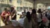 Skid Row residents go through the line, bagging basic necessities such as clothing, towels and soap. 