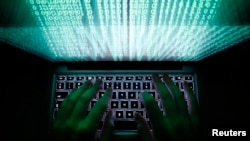 A man types on a computer keyboard in this illustration file picture. Analysts say cyber efforts by Russia to influence and subvert election in scheduled for next year in major European countries is already well underway.