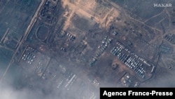This satellite image released by Maxar Technologies on Dec. 23, 2021, reportedly shows Russian ground forces deployed at the Opuk training area on Dec. 22, 2021. (Photo by Handout/Satellite image ©2021 Maxar Technologies / AFP) 