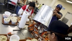 FILE - Mexican workers, on the U.S. H2B visa program for seasonal guest workers, process crabs at the A.E. Phillips & Son Inc. crab picking house on Hooper's Island in Fishing Creek, Maryland, Aug. 26, 2015. 