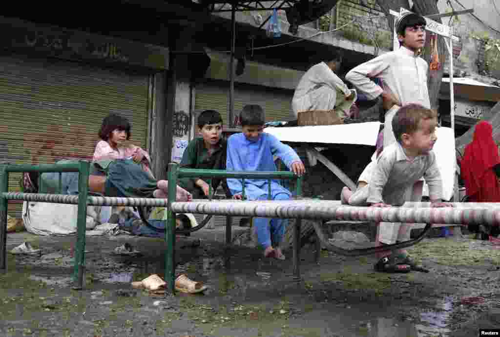 Refugees, who fled the military offensive against the Pakistani militants in North Waziristan, sit on a bed in Bannu, Khyber-Pakhtunkhwa, Pakistan, June 19, 2014.