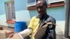 Adrian Munjere, who sustained fractures on his right hand during post-election clashes between security forces and protesters Aug. 1, displays his doctor’s report in Harare, Oct. 17, 2018. 