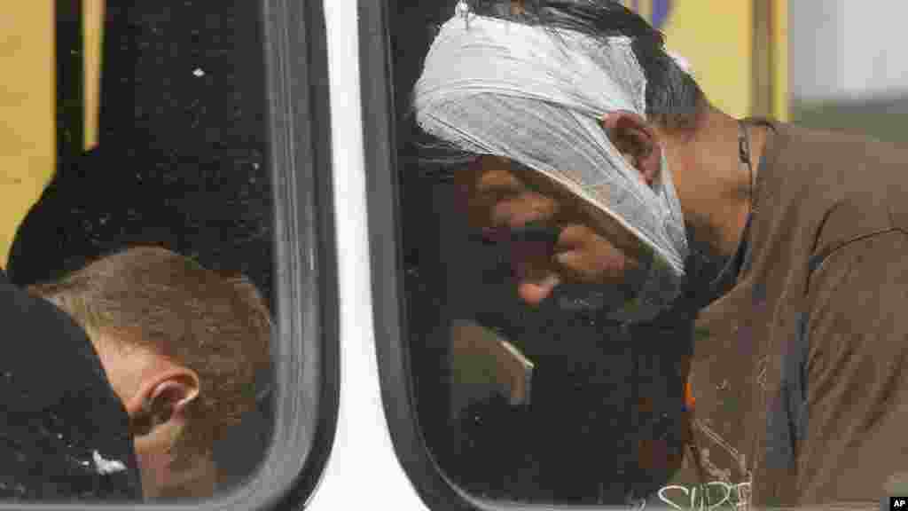 Captured Ukrainian army prisoners sit in a bus after they were escorted by Pro-Russian rebels in Donetsk, eastern Ukraine, Aug. 24, 2014.
