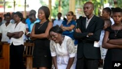Relatives attend a funeral for people who were killed in the past weeks' protest, in Port-au-Prince, Haiti, Nov. 19, 2019. 