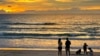 Tourists stand on Bang Tao Beach in Phuket, southern Thailand, Oct. 22, 2021. 
