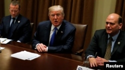 President Donald Trump meets with a bipartisan group of members of Congress, including Representative Josh Gottheimer, D-N.J., at left, and Representative Tom Reed, R-N.Y., at the White House in Washington, Sept. 13, 2017. 