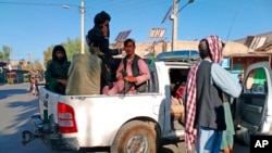 FILE - Taliban fighters patrol inside the city of Farah, capital of Farah province southwest of Kabul, Afghanistan, Aug. 11, 2021. 