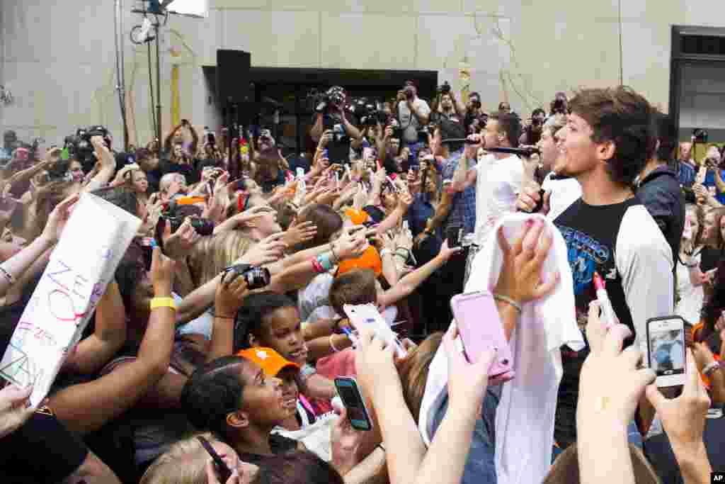 One Direction members, from right, Louis Tomlinson, Niall Horan, Liam Payne and Harry Styles, perform on NBC's "Today" show in New York.