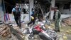 FILE - Security personnel inspect the Kok Po district office after being attacked by a group of gunmen in Pattani province, south of Bangkok, Sept. 11, 2014. 