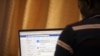 A man opens the Facebook page on his computer to fact check coronavirus disease (COVID-19) information, in Abuja, Nigeria March 19, 2020. Picture taken March 19, 2020. REUTERS/Afolabi Sotunde