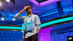 FILE - Shourav Dasari, 13, of Spring, Texas, pauses during the morning round of the finals of the 2016 National Spelling Bee, in National Harbor, Maryland, May 26, 2016. 