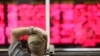 FILE - An Iranian man monitors the stock market at Tehran Stock Exchange, July 1, 2019.
