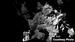 FILE - Rosetta’s lander Philae is safely on the surface of Comet 67P/Churyumov-Gerasimenko, as these first two CIVA images confirm. One of the lander’s three feet can be seen in the foreground. The image is a two-image mosaic, Nov. 13, 2014. (Courtesy: ESA) 