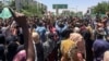 Protesters rally in front of the military headquarters in the capital Khartoum, Sudan, Monday, April 8, 2019.