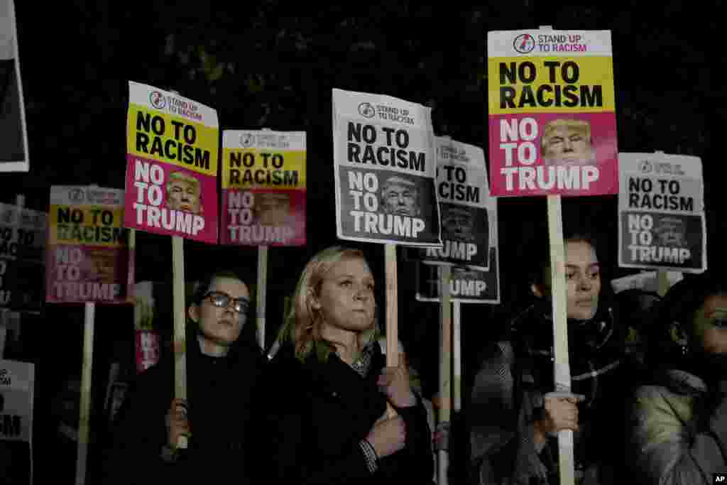 People hold placards as they take part in an anti-racism protest against President-elect Donald Trump winning the American election, outside the U.S. embassy in London, Nov. 9, 2016.