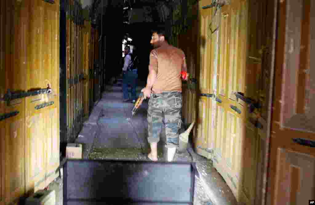 A member of the Free Syrian Army patrols through the alleys of the old part of Aleppo, October 16, 2012.