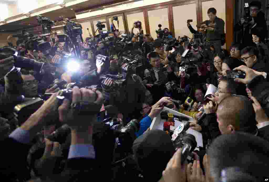 A spokesperson, right, from the Malaysia Airlines speaks to the media during a news conference at a hotel in Beijing, China. Search teams across Southeast Asia scrambled to find a Malaysia Airlines Boeing 777 with 239 people on board that disappeared from air traffic control screens over waters between Malaysia and Vietnam early morning.