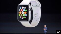 FILE - Apple CEO Tim Cook introduces the new Apple Watch on Tuesday, Sept. 9, 2014, in Cupertino, Calif. Apple's new wearable device marks the company's first major entry in a new product category since the iPad's debut in 2010.