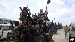 Al-Shabab fighters display weapons as they conduct military exercises in northern Mogadishu, Somalia, (File).