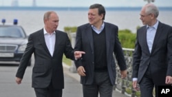Russian President Vladimir Putin, left, European Commission President Jose Manuel Barroso, center, and European Council President Herman Van Rompuy walk during the Russia EU Summit outside St.Petersburg, Russia, Sunday, June 3, 2012. 
