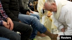 Pope Francis washes the foot of a prisoner at Casal del Marmo youth prison in Rome, Italy, March 28, 2013.