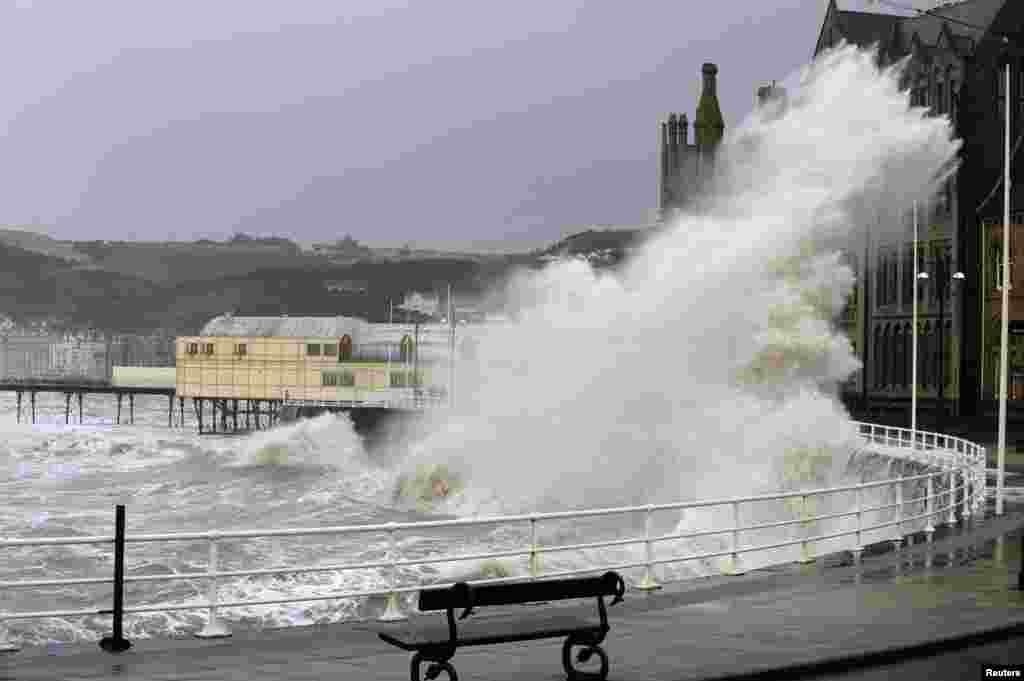 A large wave crashes over the promenade in Aberystwyth, mid Wales, Britain.