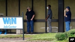 FILE - Clients line up outside the Mississippi Department of Employment Security WIN Job Center in Pearl, Aug. 31, 2020. 