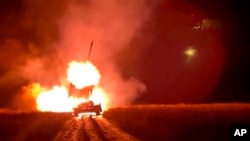 FILE - In this image taken from video distributed by the Russian Defense Ministry Press Service on Jan. 16, 2025, a Russian TOS-1A Solntsepyok heavy flamethrower rocket launcher fires towards the Ukrainian positions. 