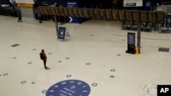 Social distancing guidelines on the floor by train departure information screens to help stop the spread of coronavirus in Waterloo station, London, June 4, 2020.