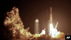 A SpaceX Falcon heavy rocket lifts off from pad 39A at the Kennedy Space Center in Cape Canaveral, Fla., June 25, 2019.