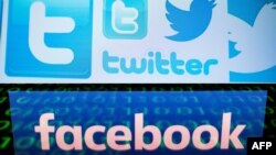 (COMBO) This combination of pictures created on August 22, 2018 shows a photo illustration taken on March 23, 2018 of Twitter logos on a computer screen in Beijing and a file illustration picture taken on April 28, 2018 of the logo of social network Faceb