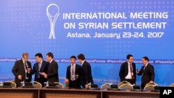 Kazakhstan officials prepare working space for delegations at a hotel in Astana, Kazakhstan, Jan. 23, 2017.