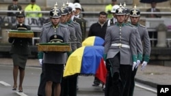 Colombian honor guards carry the coffins of four members of the security forces during their funeral at Bogota's cathedral, November 29, 2011.