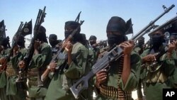 FILE - Islamist fighters loyal to Somalia's al-Shabab group perform military drills at a village in Lower Shabelle region, some 25 kilometers outside Mogadishu.