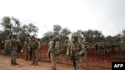 Turkish soldiers gather in the village of Qaminas, about 6 kilometers southeast of Idlib city in northwestern Syria, Feb. 10, 2020. 
