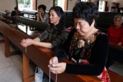 Catholics who traveled from Shanghai to Bangkok to attend mass held by Pope Francis, pray at the Holy Redeemer Church in Bangkok, Thailand, Nov. 19, 2019.
