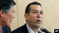 FILE - OneWest President and CEO Joseph Otting (right) participates in a public meeting at the Los Angeles branch of the Federal Reserve Bank of San Francisco, Feb. 26, 2015.