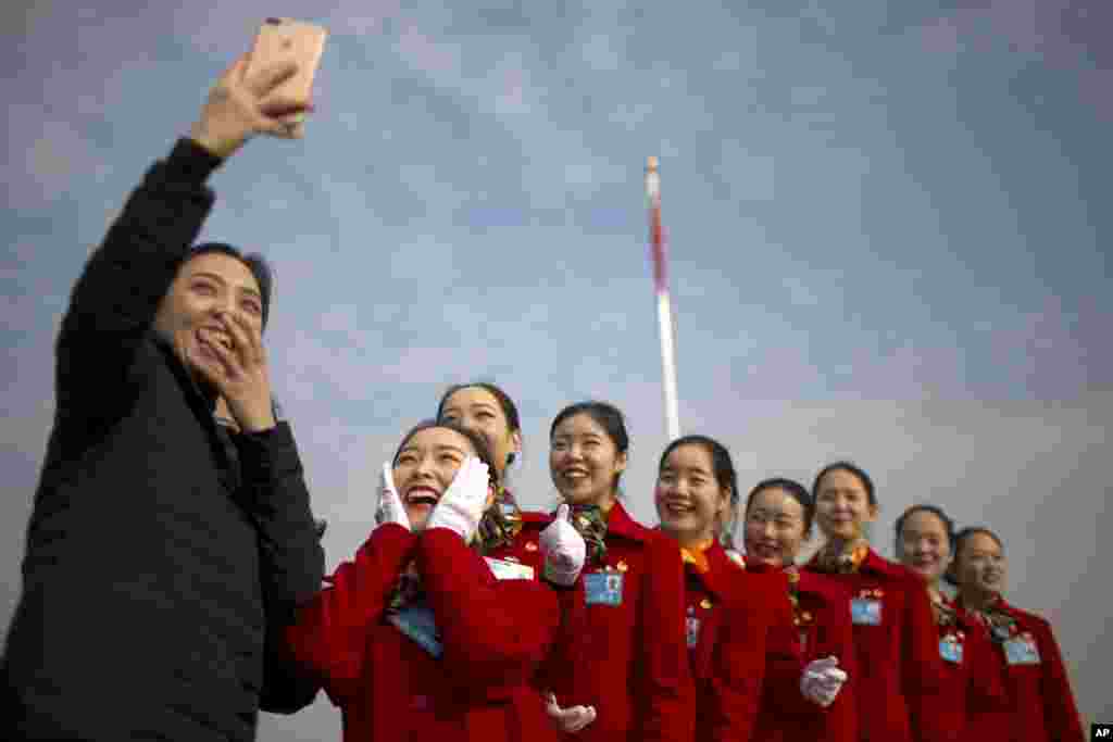 中国全国人大举行开幕式之际，在人民大会堂外面，服务员自拍。（2018年3月5日）