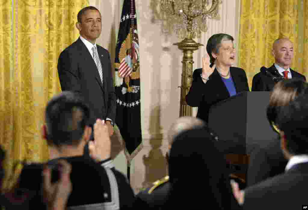 President Barack Obama listens as Homeland Security Secretary Janet Napolitano delivers the oath of allegiance during a naturalization ceremony for active duty service members and civilians at the White House, March 25, 2013.