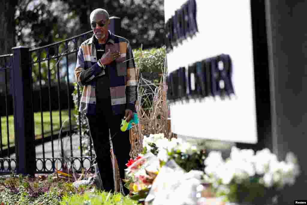 Jumbe Sebunya of Eswatini pays his respects to former U.S. President Jimmy Carter, who died at the age of 100, by the sign of The Carter Presidential Center, in Atlanta, Georgia, Dec. 30, 2024.