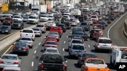 FILE - Traffic on Interstate 5 moves through Los Angeles, Sept. 1, 2006.