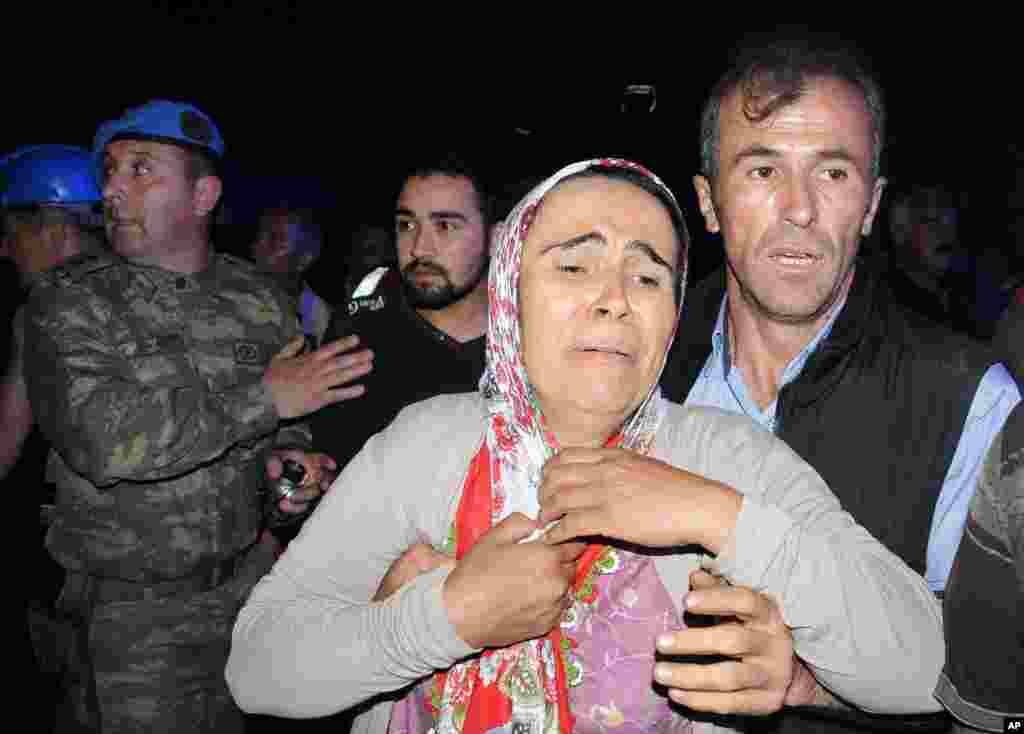 Family members gather near the mine after a deadly explosion and fire at a coal mine in Soma, western Turkey, May 13, 2014.