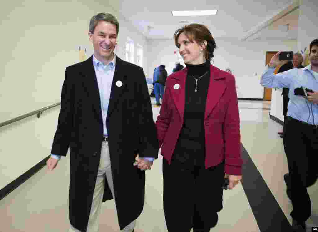 Virginia Attorney General Ken Cuccinelli and his wife Teiro leave the polling station after casting their votes at Brentsville District High School in Nokesville, Va., Nov. 5, 2013.
