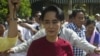 Myanmar opposition leader and head of the National League for Democracy (NLD) Aung San Suu Kyi (C) visits a polling station in Kawhmu township, Yangon, Nov. 8, 2015. 