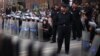 Police stand guard during a protest against the military council outside Egypt's parliament in Cairo, June 19, 2012. 