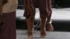 FILE - The shackled legs of suspected human traffickers are seen as they arrive for their trial at the criminal court in Bangkok, Thailand, March 15, 2016.