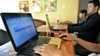 Cambodian men using the Internet at a coffee shop in Phnom Penh.