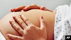 Pregnant woman in hospital gown