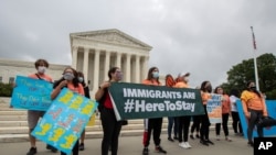 FILE - Deferred Action for Childhood Arrivals students celebrate in front of the Supreme Court after it rejected President Donald Trump's effort to end legal protections for young immigrants, in Washington, June 18, 2020.